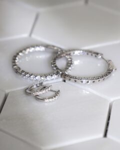 white gold rings with diamonds, on top of tiles