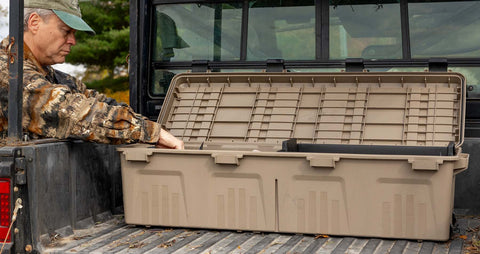 hunter reaching into a mtm mule mobile gear crate