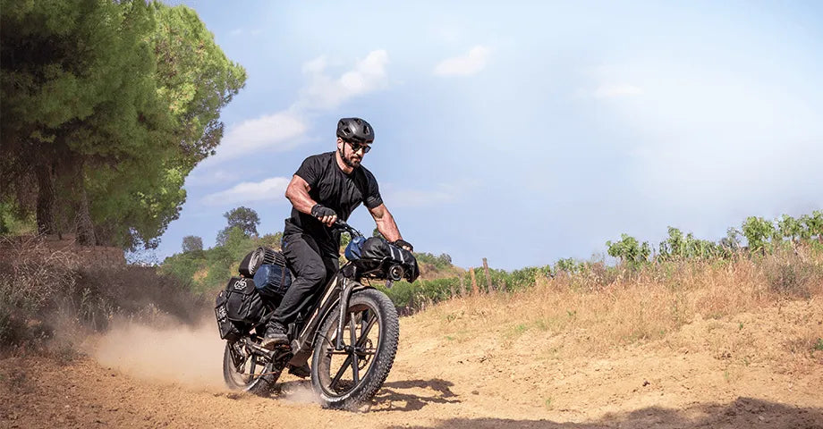 Homme monté sur un vélo électrique Fiido Titan sur le sable