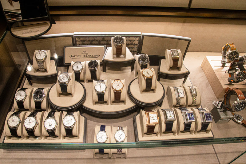 A display case in the watch salon showcasing an array of Jaeger LeCoultre timepieces.