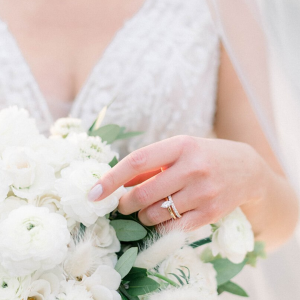 Bride holding flowers with gold band diamond ring