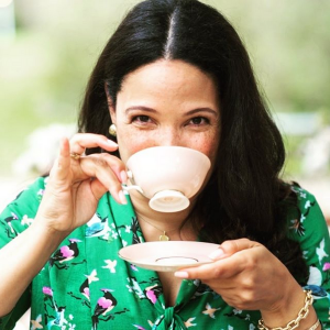 Mary Harris sips from a tea cup.