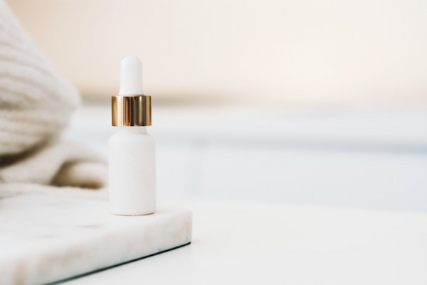 A clean beauty brand's product made from natural, renewable ingredients in a dropper bottle on a white background