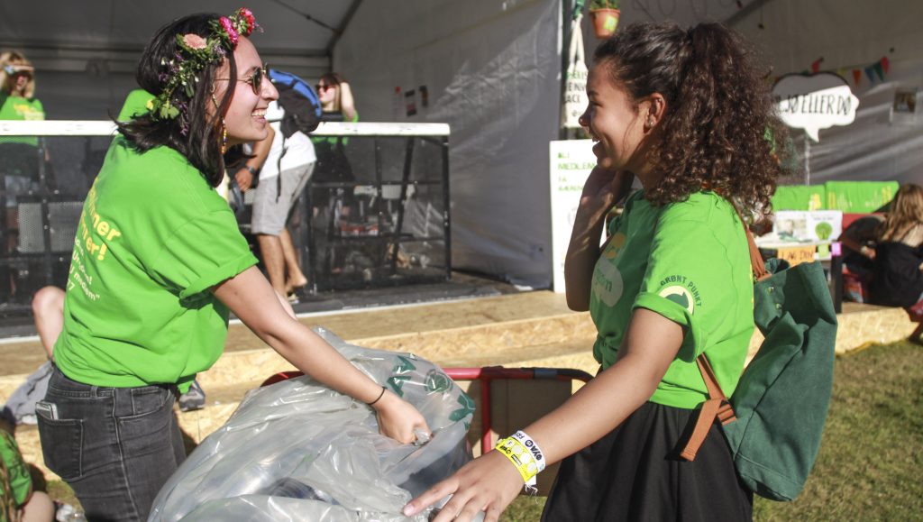 2 Women Bonding Over Trash Collection At Music Festival