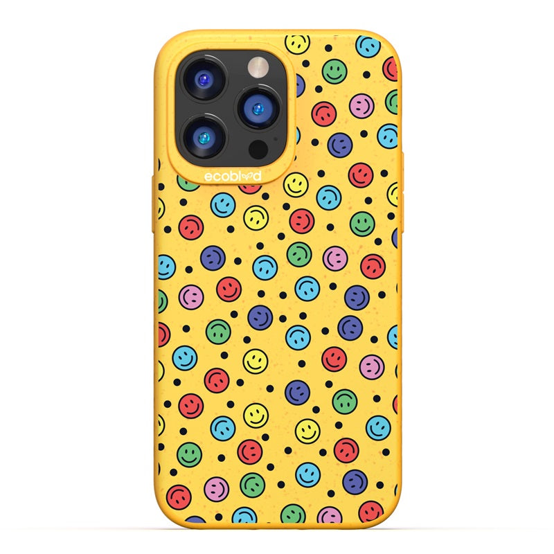 Sequoia Collection - Yellow Compostable iPhone 14 Pro Max Case With Multicolored Smiley Faces And Black Dots On A Solid Back