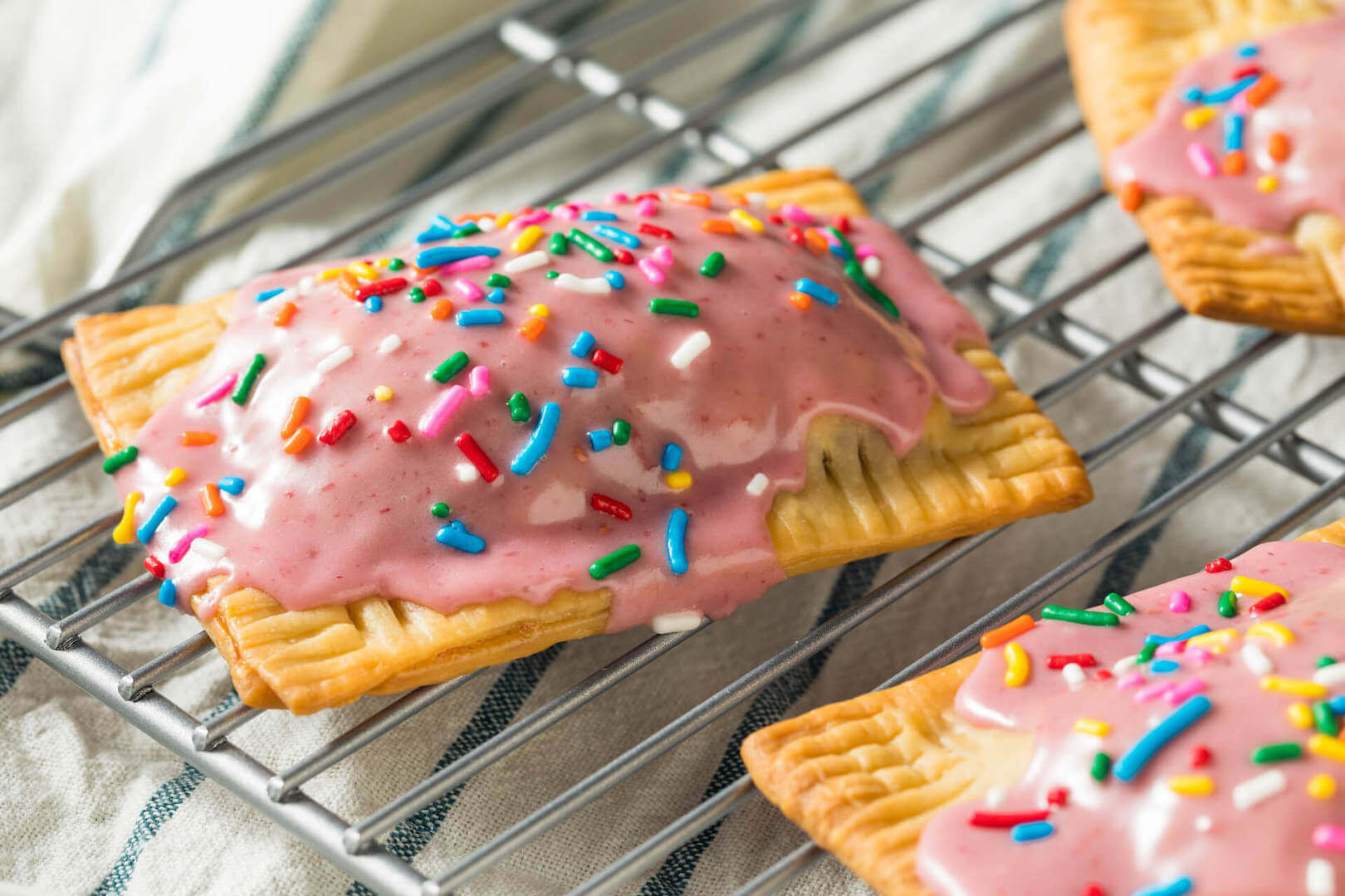 Toaster pastries with pink icing and rainbow sprinkles