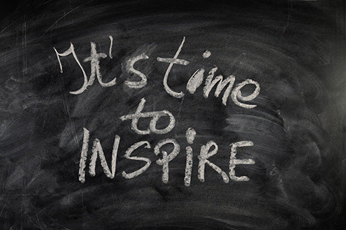 "It's time to inspire" words on chalkboard.