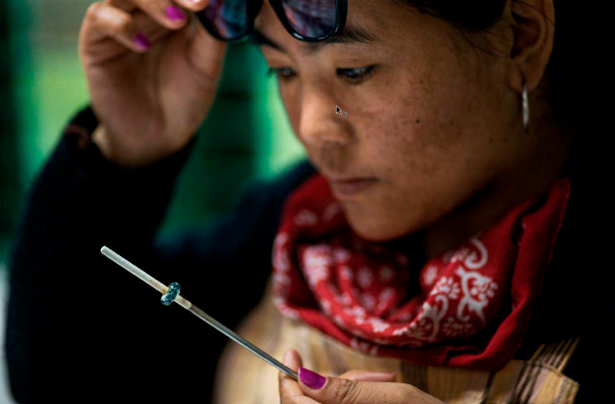 Woman working on a glass bead