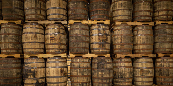 Used oak whiskey and bourbon barrels stacked on pallets