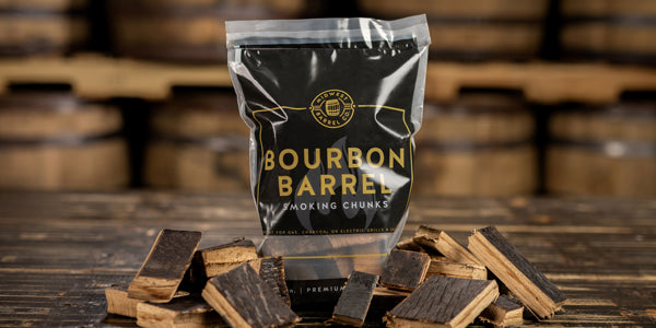 A bag of bourbon barrel BBQ smoking wood chunks and a pile of extra chunks