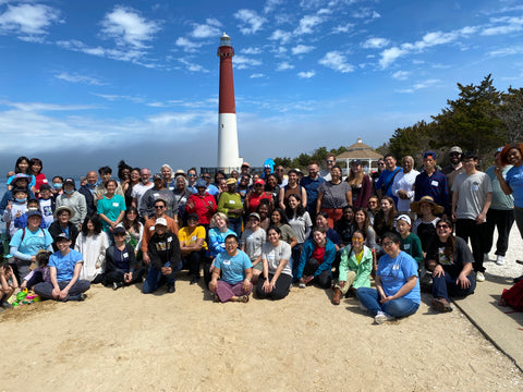 A full group shot of all the dock trip participants in front of the Barnegat Light lighthouse