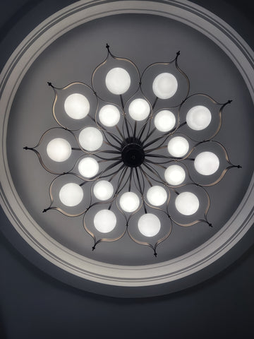 black and white image of a beautiful light fixture