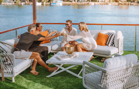 Enjoy a leisurely outdoor experience on a plush Colwood Lounge in light grey, paired with a chic Bradford coffee table in white. This elegant setup is perfect for socializing and soaking in the tranquil views of the waterfront.