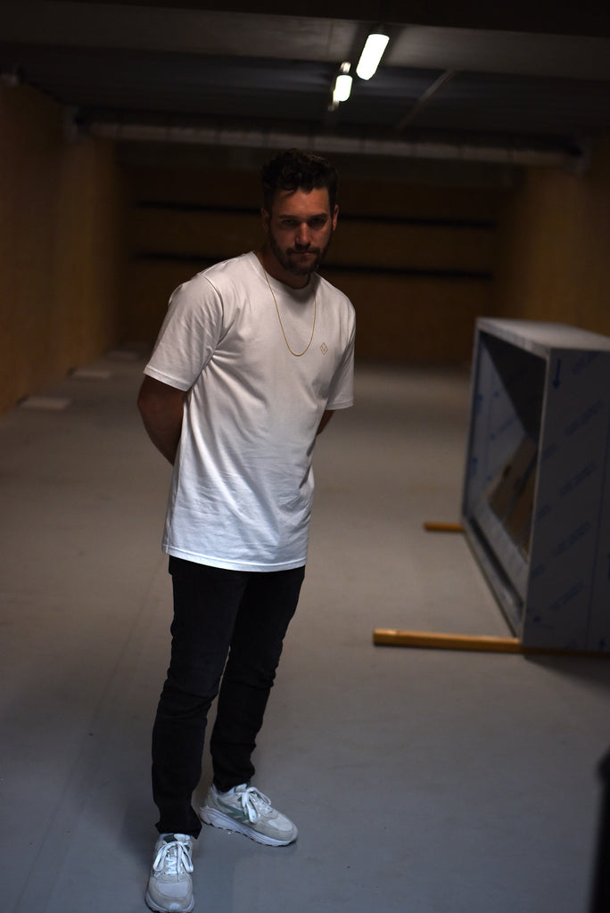 Michael Schook posing in basement in MVDT T-shirt white