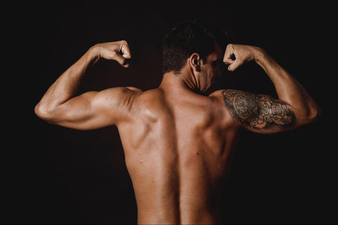 man flexing his back muscles