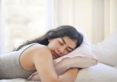 an athletic woman sleeping in bed