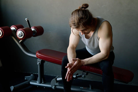 a fit man resting in the gym