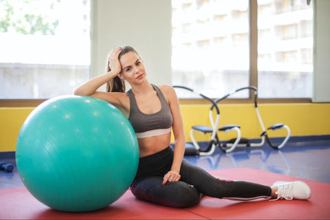 Girl sitting with exercise ball