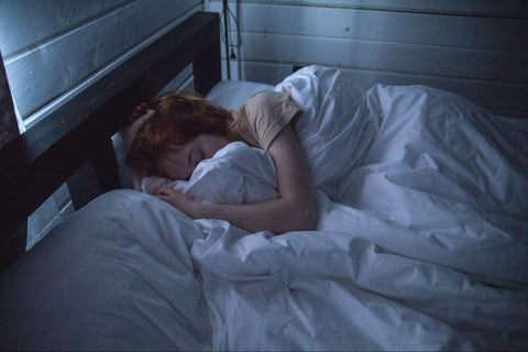 a woman sleeping in bed