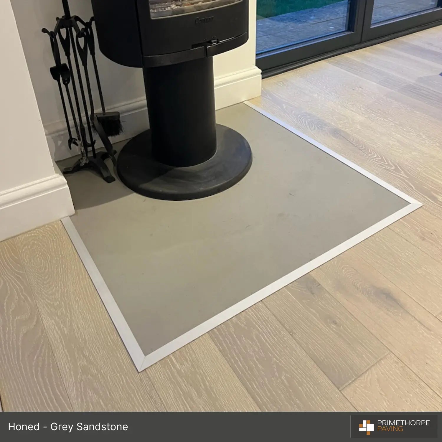 Contemporary honed sandstone hearth recessed into floor