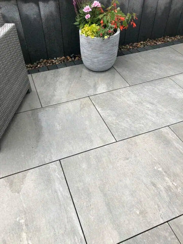 Grey quartz porcelain paving. Grey porcelain paving next to plant pot.