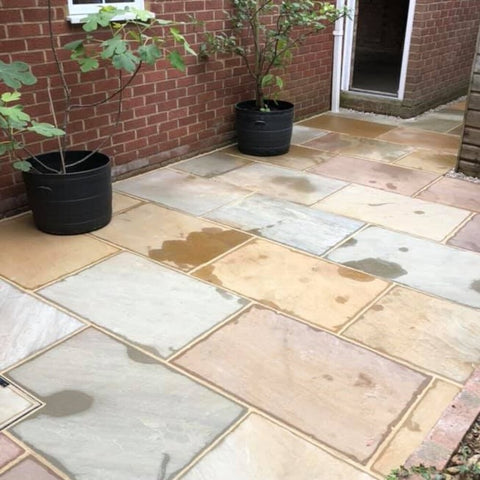 Rippon buff sandstone paving. Sandstone paving next to shed.