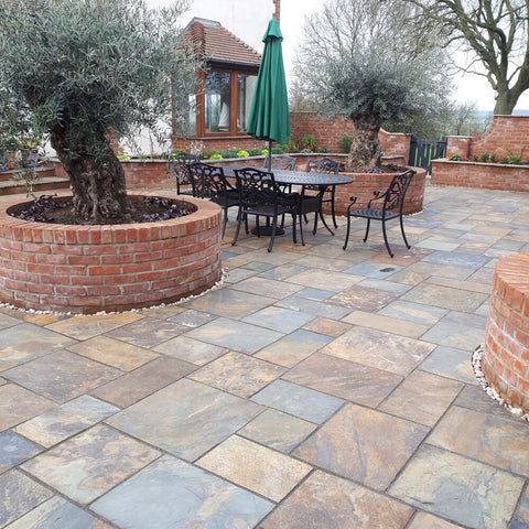 Gold slate paving. Slate paving patio with outdoor chair and table.