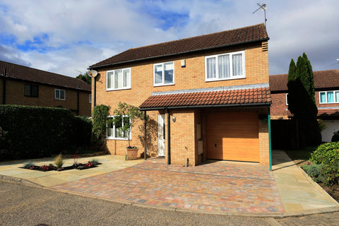 front of a house with yellow limestone paving and a block paving section