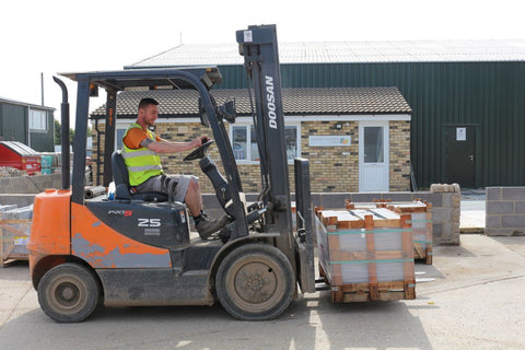 Man on forklift loading high-quality paving slabs for delivery to customers at Primethorpe Paving