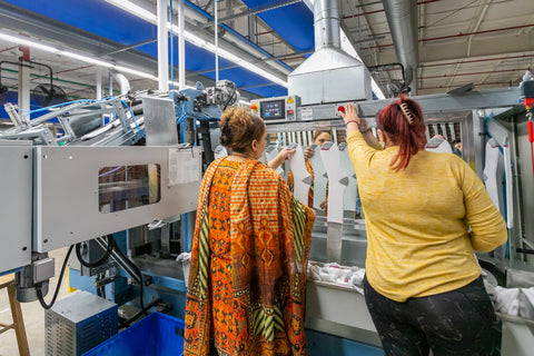 Two employees checking the quality of socks