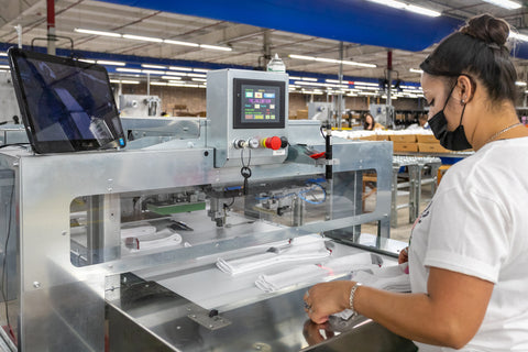 Employee inspecting the automatic folding machine. 