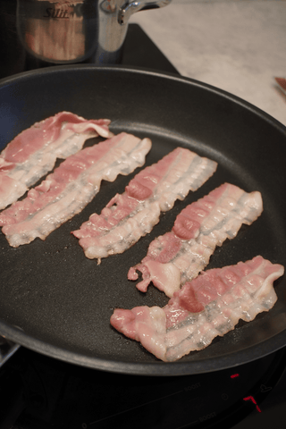 Frying bacon in a pan