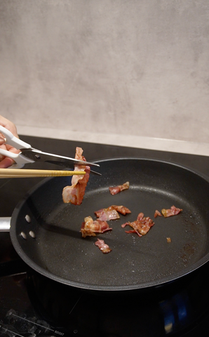 Cutting bacon into bite-sized pieces