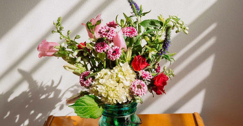 Artificial flower arrangement NZ-sun streaming through window