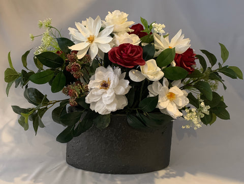 Peonie and roses in black stone oval vase.