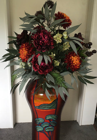 Transforming Your Vase into a Stunning Masterpiece! Artificial flower arrangement for Morris and James pot. Balance Due NZD250.00 Peonies and chrysanthemums, in complementary tones of deep burgundy, orange and winter white, with eucalyptus leaves, mini-b