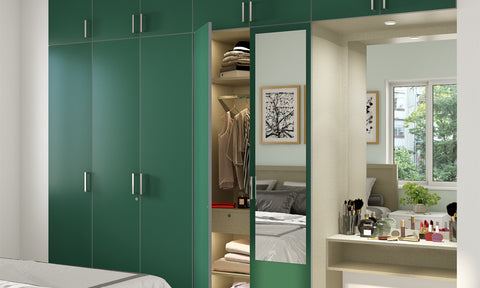 Master bedroom wardrobe design with a dressing table in dark green colour