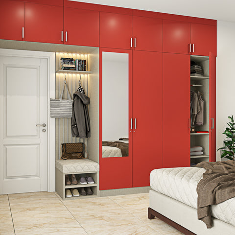 A modern wardrobe designed in a rose-red colour and includes shoe storage