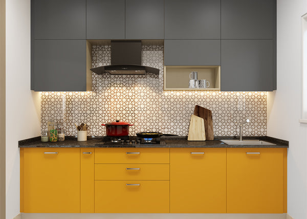 Yellow and grey acrylic kitchen cabinets paired with a geometric backsplash