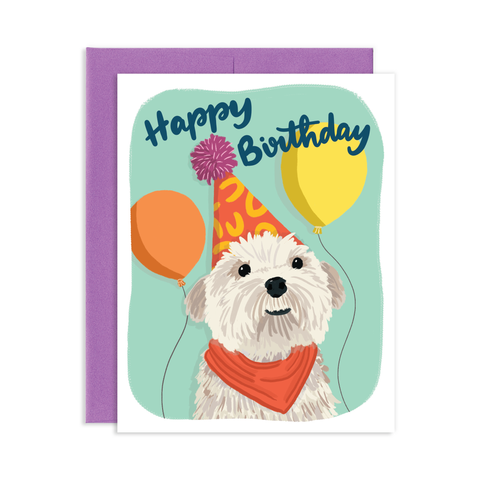 Birthday greeting card with a purple envelope. Greeting card has a small fluffy white dog in a birthday party hat surrounded by balloons