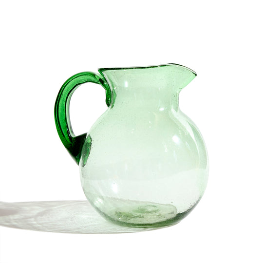 https://cdn.shopify.com/s/files/1/0635/1691/files/Global-Goods-Partners-Verde-Barriga-Glass-Pitcher-Carafe-Jug-Left_540x.jpg?v=1698352562