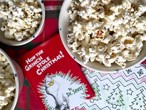 Popcorn in handmade Irish pottery bowls from Charlie Mahon Ceramics Pottery in Cork, Ireland beside a copy of How The Grinch Stole Christmas by Dr. Seuss.