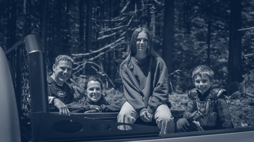 Wickum family posing with truck in black and white