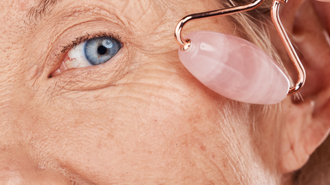 rose quartz roller on mature skin blue eyes