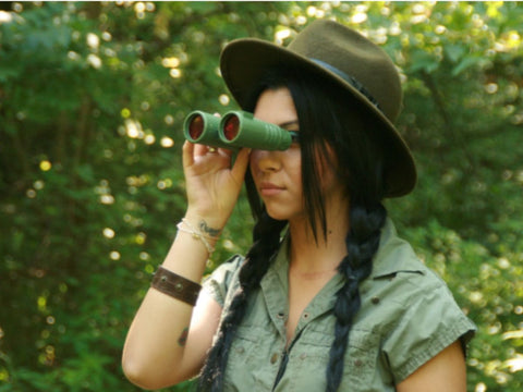 01 a women is using binoculars to observe