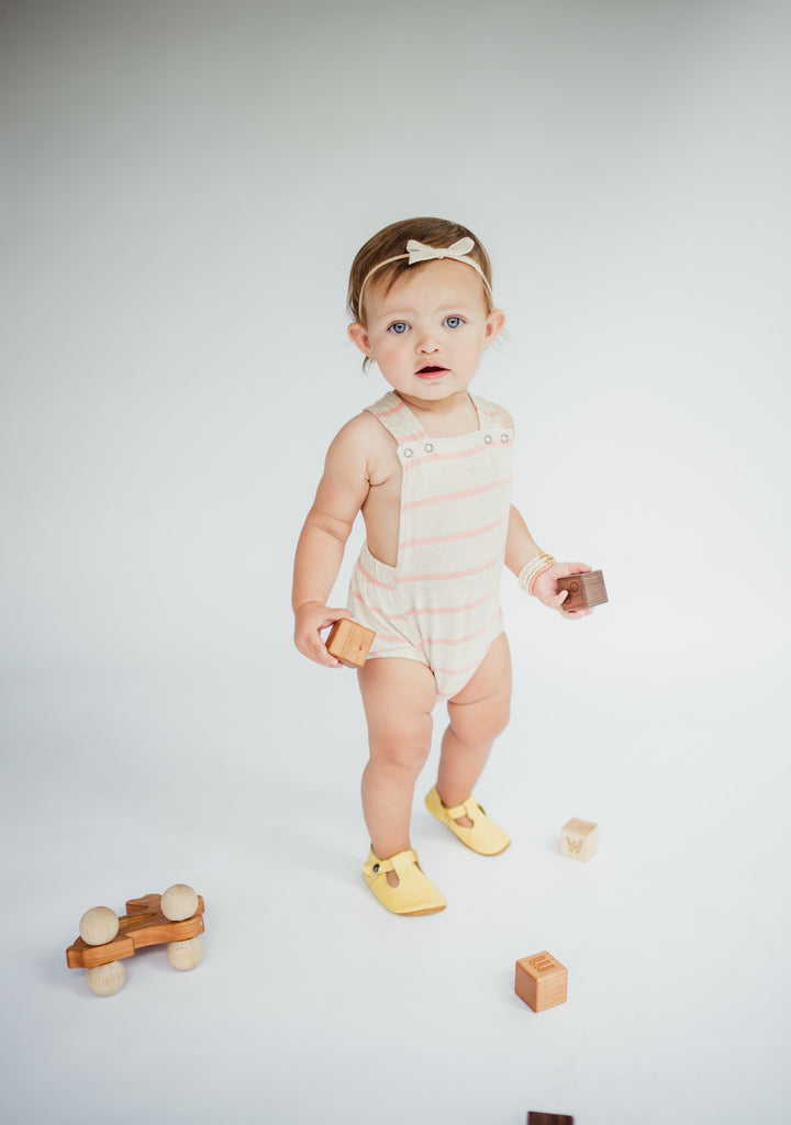 sweet orange photography of littlemissdessa baby girl in modern short romper with bannor toys