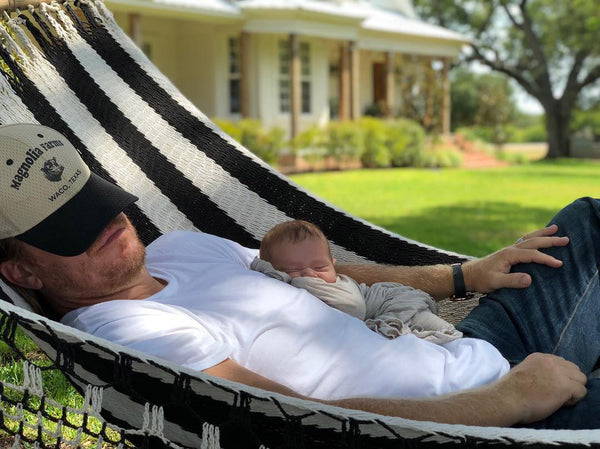 Chip Gaines with baby boy swaddled in baby blanket from LITTLEMISSDESSA