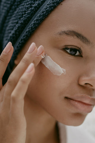 Woman applying sunscreen to her face