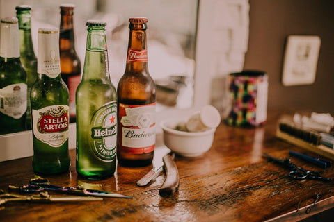 3 bottles of beer on a bedroom dresser