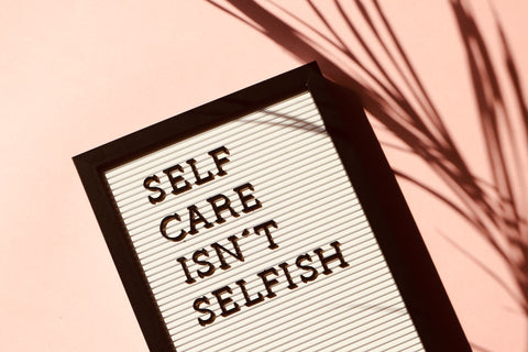 "Self care isn't selfish" written on a wall